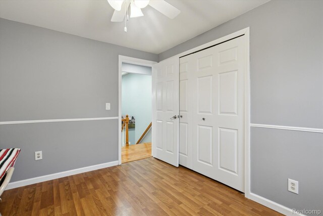 13439 Brougham Dr, Warren, MI 48312 - unfurnished bedroom featuring wood finished floors, a closet, baseboards, and a ceiling fan