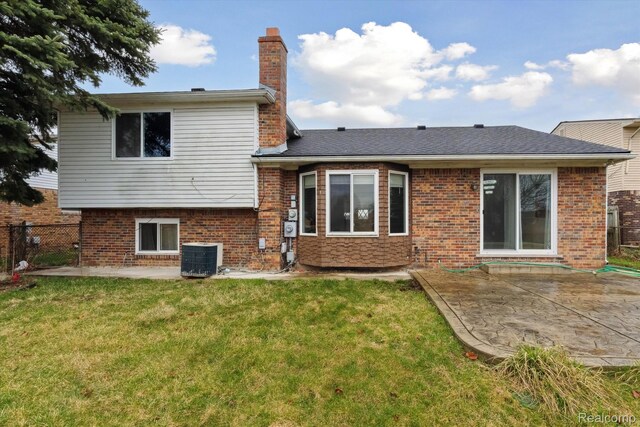 13439 Brougham Dr, Warren, MI 48312 - back of property featuring a patio, a chimney, central AC unit, and brick siding