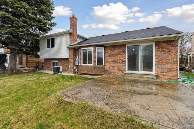 13439 Brougham Dr, Warren, MI 48312 - rear view of house with central air condition unit, a patio area, brick siding, and a chimney