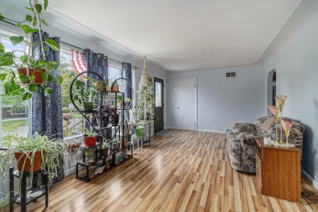 299 5th Ave, Manistee, MI 49660 - sitting room featuring arched walkways, wood finished floors, and baseboards