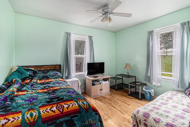 299 5th Ave, Manistee, MI 49660 - bedroom featuring multiple windows, light wood-style floors, and a ceiling fan