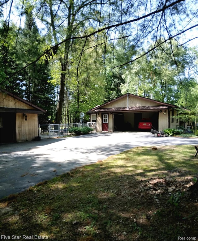 1578 Evergreen Dr, West Branch, MI 48661 - view of property exterior featuring concrete driveway