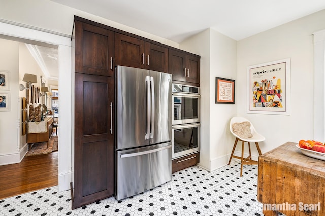 573 College Ave SE, Grand Rapids, MI 49503 - kitchen featuring stainless steel appliances, dark brown cabinetry, and baseboards