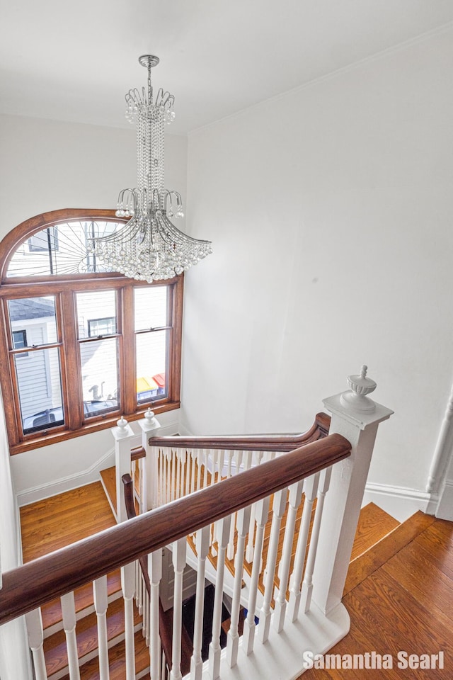 573 College Ave SE, Grand Rapids, MI 49503 - stairway featuring a chandelier, healthy amount of natural light, and baseboards