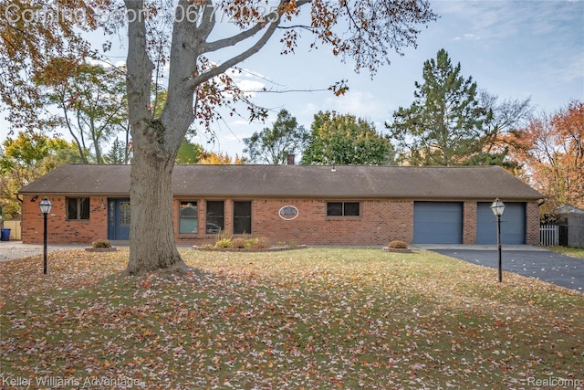 4879 Sundale Dr, Clarkston, MI 48346 - ranch-style home with driveway, brick siding, an attached garage, and a front lawn