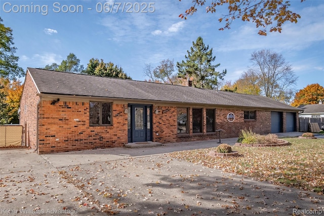 4879 Sundale Dr, Clarkston, MI 48346 - ranch-style house with brick siding, concrete driveway, an attached garage, and a shingled roof