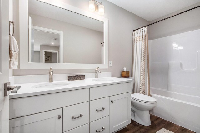 883 Water Ridge Dr, Byron Center, MI 49315 - full bath featuring double vanity, wood finished floors, shower / bathtub combination with curtain, and toilet