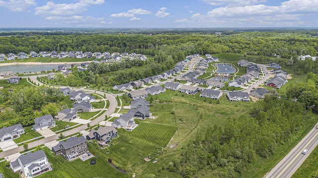 883 Water Ridge Dr, Byron Center, MI 49315 - aerial overview of property's location featuring a heavily wooded area, nearby suburban area, and a nearby body of water