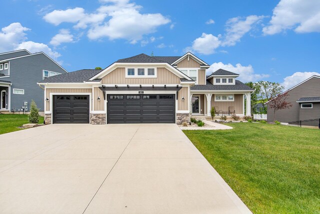 883 Water Ridge Dr, Byron Center, MI 49315 - craftsman-style house with board and batten siding, an attached garage, stone siding, driveway, and covered porch