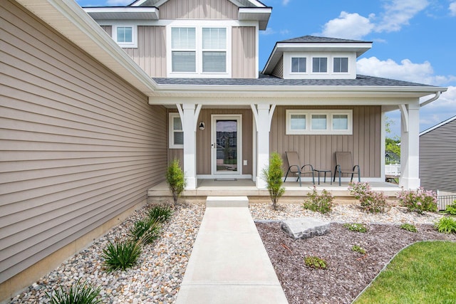 883 Water Ridge Dr, Byron Center, MI 49315 - view of exterior entry featuring a porch, board and batten siding, and roof with shingles