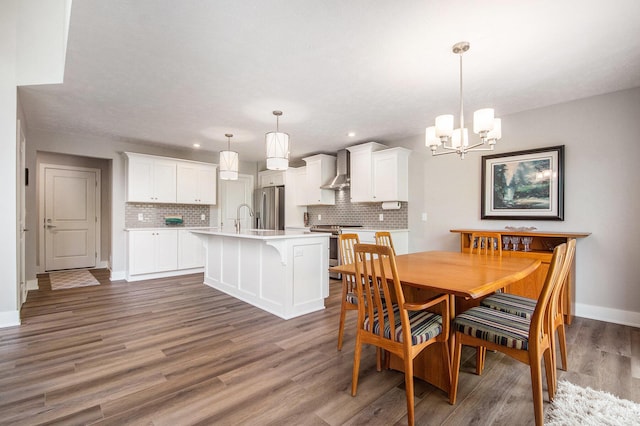 883 Water Ridge Dr, Byron Center, MI 49315 - dining room with a chandelier, wood finished floors, baseboards, and recessed lighting