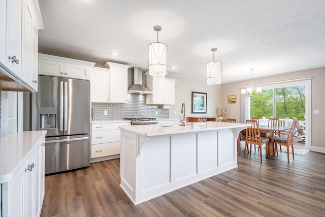 883 Water Ridge Dr, Byron Center, MI 49315 - kitchen featuring wall chimney exhaust hood, stainless steel fridge with ice dispenser, light countertops, stove, and dark wood-style flooring