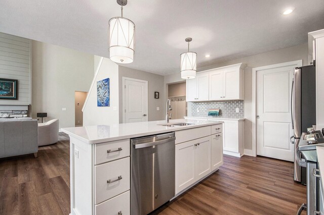 883 Water Ridge Dr, Byron Center, MI 49315 - kitchen with appliances with stainless steel finishes, a sink, dark wood-type flooring, decorative backsplash, and recessed lighting