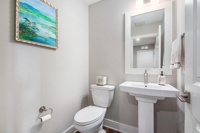 883 Water Ridge Dr, Byron Center, MI 49315 - half bath featuring toilet and baseboards