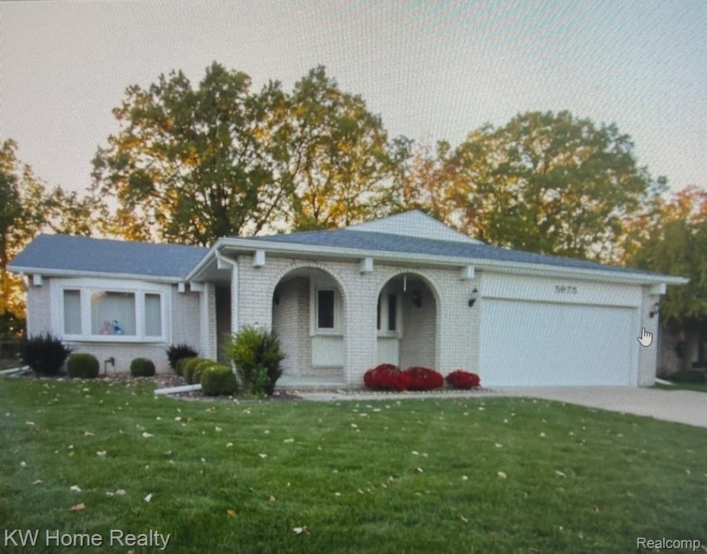 5975 Beaufort Dr, Canton, MI 48187 - single story home featuring a front yard, brick siding, an attached garage, and concrete driveway