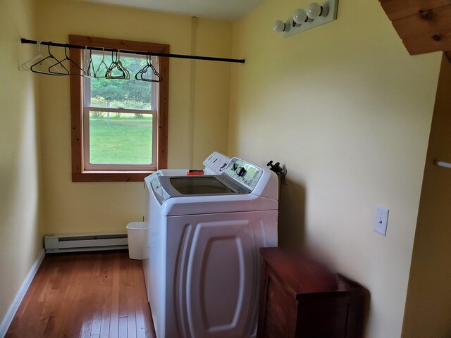 3354 E Arthur, Rothbury, MI 49452 - laundry area featuring baseboard heating, wood finished floors, separate washer and dryer, and baseboards