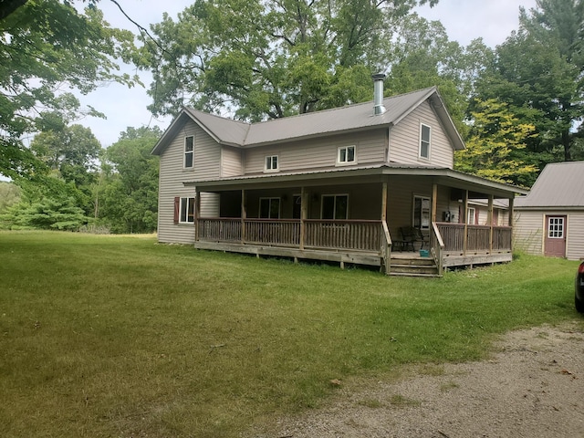 3354 E Arthur, Rothbury, MI 49452 - view of front facade with a front lawn, metal roof, and a wooden deck