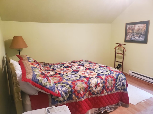 3354 E Arthur, Rothbury, MI 49452 - bedroom with wood finished floors, a baseboard heating unit, and vaulted ceiling