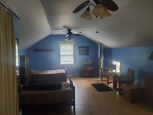 3354 E Arthur, Rothbury, MI 49452 - bedroom featuring wood finished floors, lofted ceiling, ceiling fan, and baseboard heating