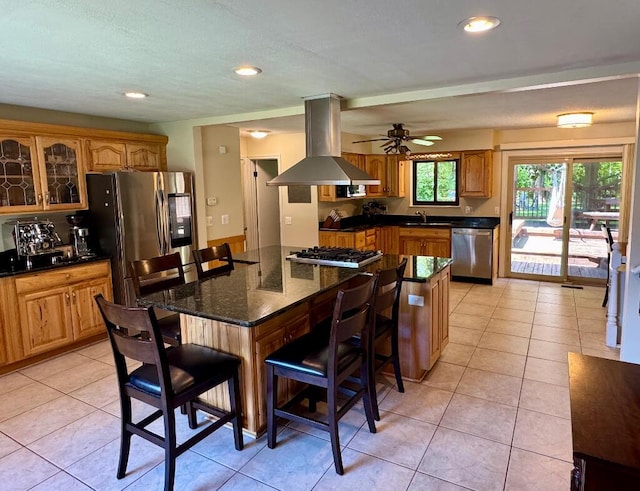 3671 Lido, Highland, MI 48356 - kitchen with island range hood, stainless steel appliances, a breakfast bar area, a sink, and glass insert cabinets