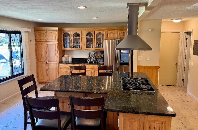 3671 Lido, Highland, MI 48356 - kitchen featuring gas stovetop, freestanding refrigerator, a textured ceiling, a kitchen island, and light tile patterned floors