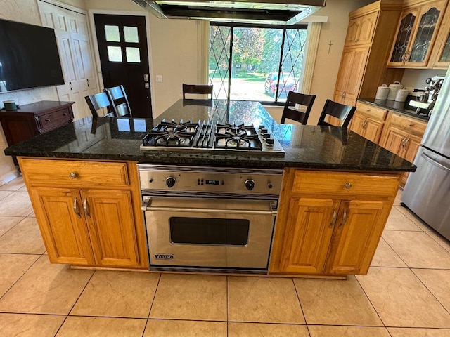 3671 Lido, Highland, MI 48356 - kitchen featuring stainless steel appliances, under cabinet range hood, light tile patterned floors, glass insert cabinets, and a center island