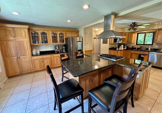 3671 Lido, Highland, MI 48356 - kitchen with stainless steel appliances, island exhaust hood, a breakfast bar, glass insert cabinets, and recessed lighting
