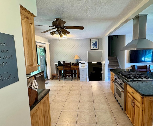 3671 Lido, Highland, MI 48356 - kitchen featuring wall chimney range hood, appliances with stainless steel finishes, a textured ceiling, a ceiling fan, and light tile patterned flooring