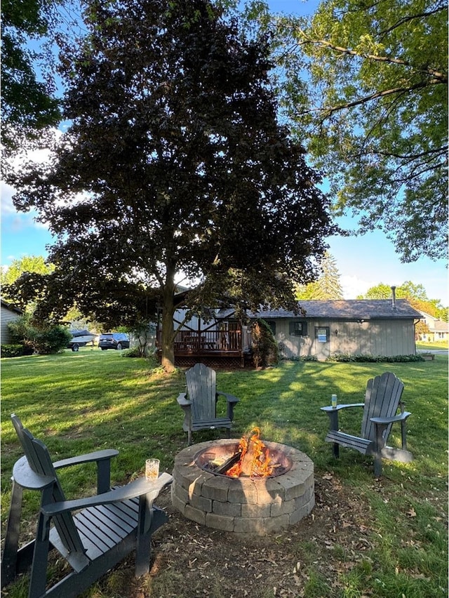 3671 Lido, Highland, MI 48356 - view of grassy yard featuring an outdoor fire pit and a deck