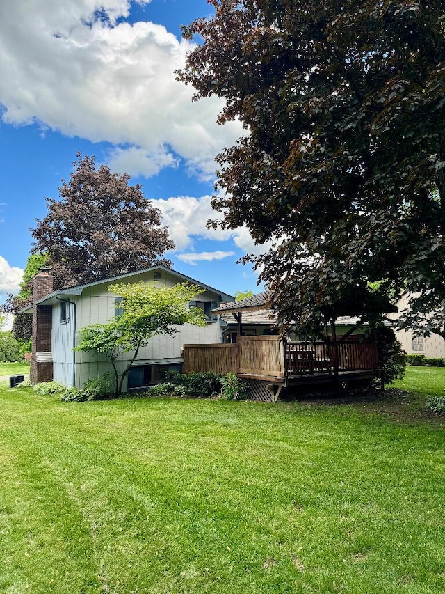 3671 Lido, Highland, MI 48356 - view of green lawn with a wooden deck