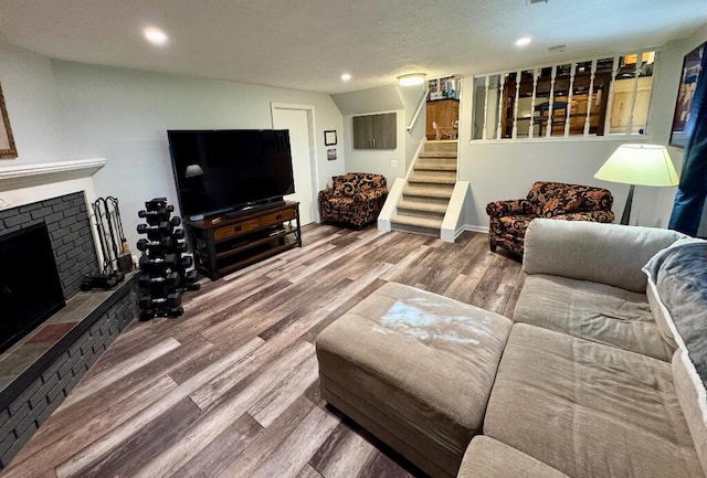 3671 Lido, Highland, MI 48356 - living area with wood finished floors, stairway, a fireplace, and recessed lighting