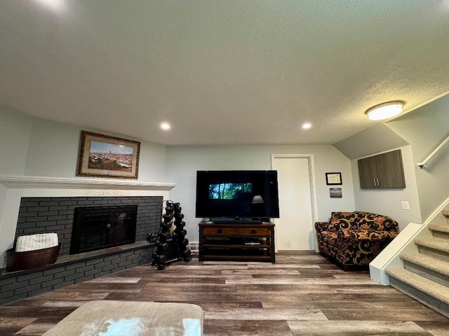 3671 Lido, Highland, MI 48356 - living area with wood finished floors, stairway, a brick fireplace, a textured ceiling, and recessed lighting
