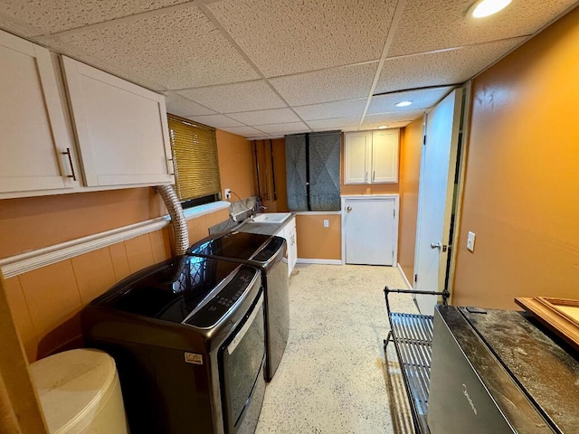 3671 Lido, Highland, MI 48356 - kitchen featuring washing machine and clothes dryer, a paneled ceiling, a sink, white cabinets, and recessed lighting