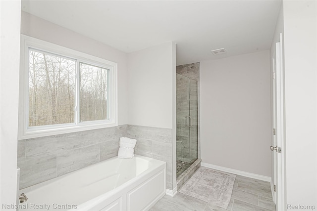 20 Medford Hill Dr, Metamora, MI 48455 - bathroom with a bath, a shower stall, and baseboards