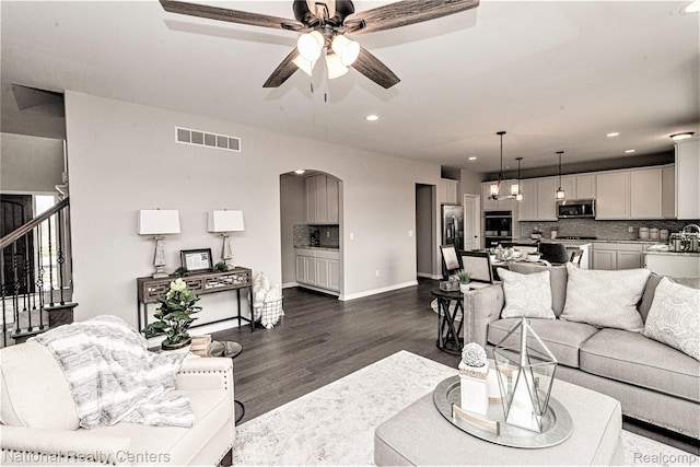 20 Medford Hill Dr, Metamora, MI 48455 - living room with dark wood-style flooring, arched walkways, recessed lighting, a ceiling fan, and baseboards