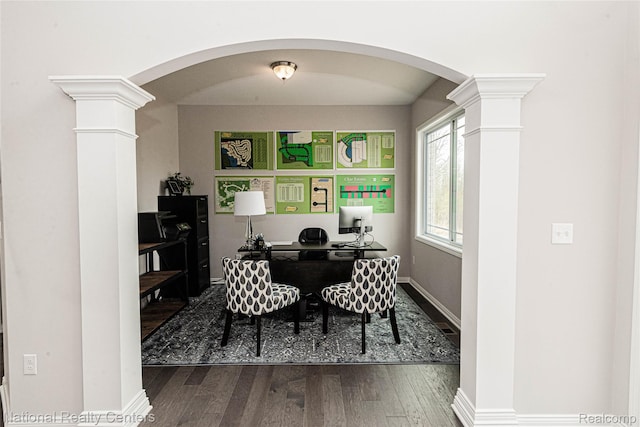 20 Medford Hill Dr, Metamora, MI 48455 - home office featuring decorative columns, arched walkways, dark wood-style flooring, and baseboards