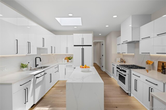 1752 Alexander Dr, Bloomfield, MI 48302 - kitchen featuring white appliances, modern cabinets, a sink, a skylight, and recessed lighting