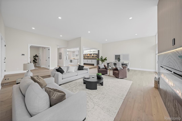 1752 Alexander Dr, Bloomfield, MI 48302 - living area featuring light wood-type flooring, a lit fireplace, recessed lighting, and baseboards