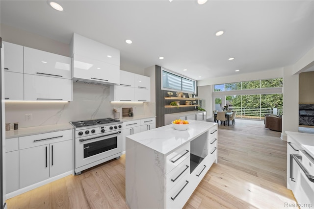 1752 Alexander Dr, Bloomfield, MI 48302 - kitchen with high end range, modern cabinets, white cabinetry, tasteful backsplash, and recessed lighting