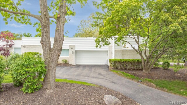 1752 Alexander Dr, Bloomfield, MI 48302 - view of front of property featuring driveway, brick siding, and a garage