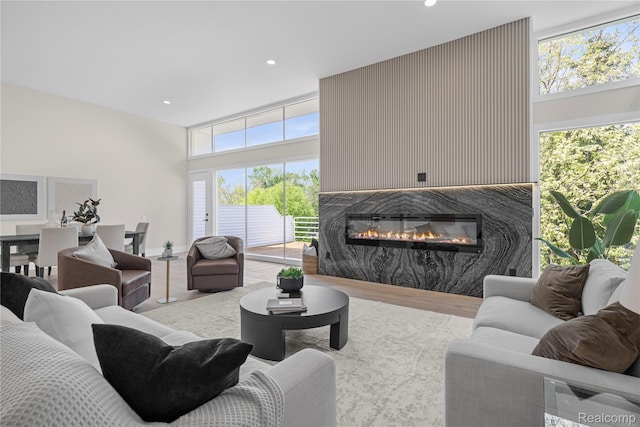 1752 Alexander Dr, Bloomfield, MI 48302 - living room featuring a high ceiling, a premium fireplace, recessed lighting, and wood finished floors