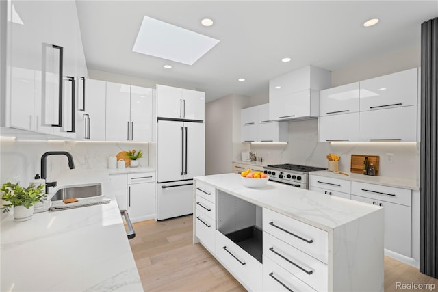 1752 Alexander Dr, Bloomfield, MI 48302 - kitchen with white appliances, modern cabinets, a skylight, a sink, and recessed lighting