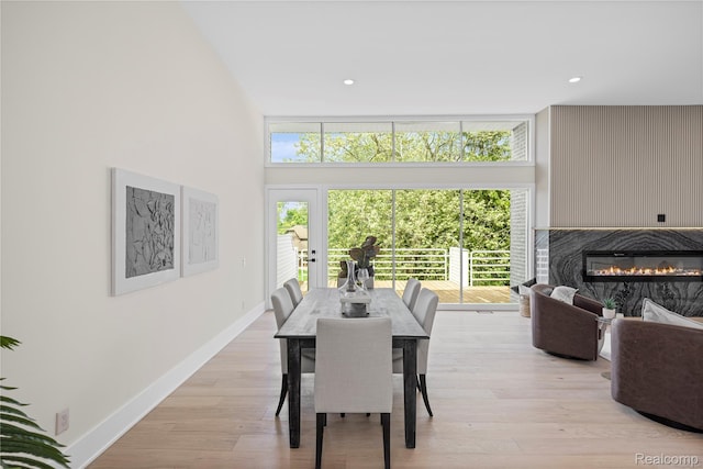 1752 Alexander Dr, Bloomfield, MI 48302 - dining space with healthy amount of natural light, a glass covered fireplace, baseboards, recessed lighting, and a towering ceiling