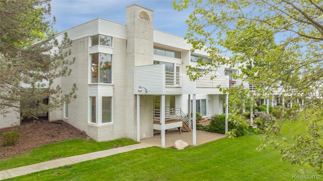 1752 Alexander Dr, Bloomfield, MI 48302 - back of property featuring a chimney, a yard, and a patio