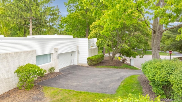 1752 Alexander Dr, Bloomfield, MI 48302 - view of home's exterior featuring asphalt driveway and brick siding