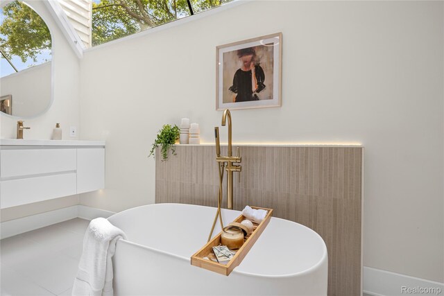 1752 Alexander Dr, Bloomfield, MI 48302 - bathroom featuring a freestanding bath, vanity, and tile patterned floors