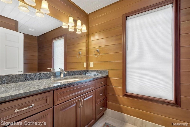 4150 Port Austin Rd, Caseville, MI 48725 - bathroom with vanity, wooden walls, and tile patterned floors
