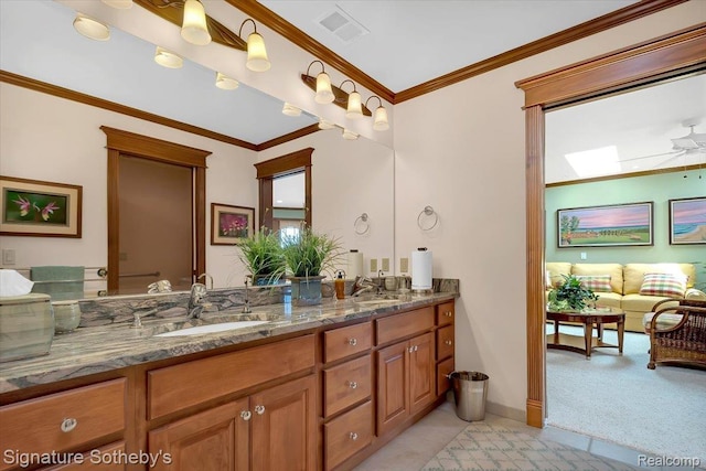 4150 Port Austin Rd, Caseville, MI 48725 - full bath with double vanity, crown molding, baseboards, and a skylight