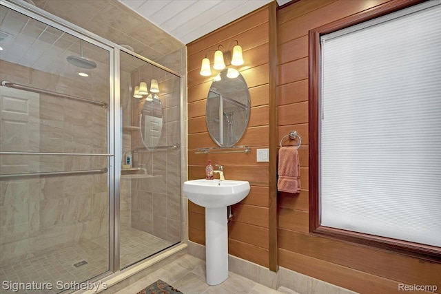 4150 Port Austin Rd, Caseville, MI 48725 - bathroom with a shower stall, wood walls, and a sink