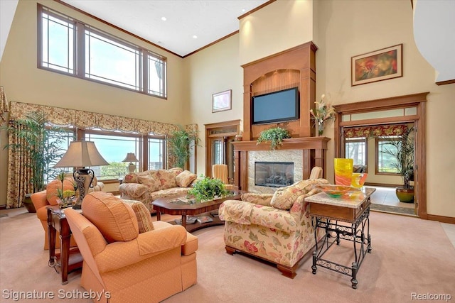 4150 Port Austin Rd, Caseville, MI 48725 - living room with a high ceiling, crown molding, light colored carpet, a high end fireplace, and baseboards